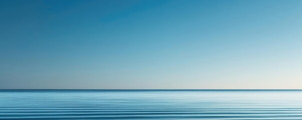 Poster - Waterscape abstract background idea. A serene view of calm ocean water against a clear blue sky.