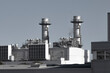 © yaqui_villegas - Industrial power plant with twin chimneys and large metallic structures, modern energy facility.