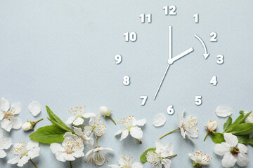 Poster - Clock and flowers on grey background, top view. Arrow showing time change one hour ahead in spring. Daylight saving time