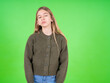 © Roquillo - beautiful teen girl wearing green sweater with sad expression covering face with hands while crying. Depression concept.