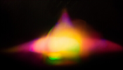 Color light overlay. Defocused yellow-pink radiance soft texture on dark black abstract empty space background. Light in the galaxy with gradient colors on black background.