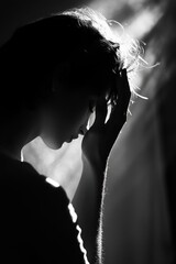 Poster - A black and white photo of a woman supporting her head with her hands, possibly in pain or distress