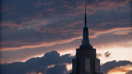 Poster - Vibrant sunset casting dramatic orange and red hues across moving clouds sweeping over building silhouette in city urban landscape