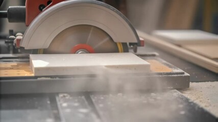 Aufkleber - White dust billowing, professional circular saw cutting cleanly through white ceramic tile on precision table saw in industrial workshop setting