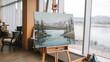 © Elina - A painting of a serene lake is on an easel by a window