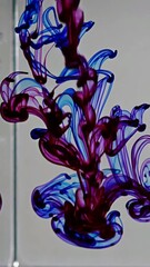 Poster - Mesmerizing swirls of blue and red ink dancing through water in three phases