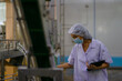 © Suney - Employee working at canned fish factory.