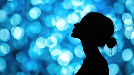 Poster - A silhouette of a woman against a glowing abstract blue background. 