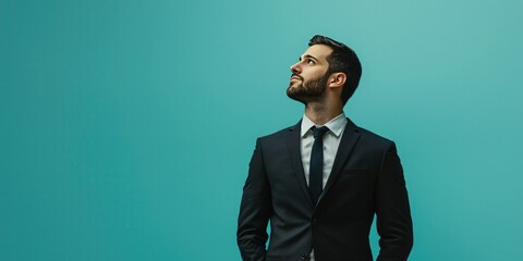 Poster - A professional man in formal attire standing against a solid blue background. 