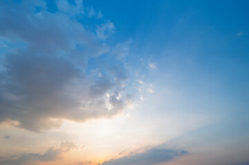 Wall Mural - sunset / sun rise sky with rays of light shining clouds and sky background and texture