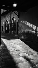 Poster - A black and white photo of an empty building exterior with no signs of life or activity