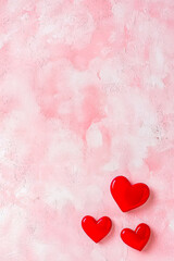 Leinwandbilder - Red heart decorations on a pink textured background celebrate love and appreciation for mothers