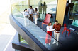 © BGStock72 - Colleagues engage in a productive discussion on a modern office balcony during a sunny afternoon