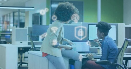 Poster - Collaborating in office, two women with digital security animation overlaying scene