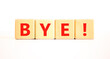 © Dzmitry - Bye symbol. Concept word Bye on beautiful wooden blocks. Beautiful white table white background. Business and bye concept. Copy space.