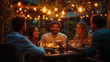 © Cristina - A man stands confidently and delivers a speech to a small group of friends seated around a table, all illuminated by warm string lights in the evening
