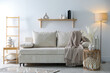 © New Africa - Comfortable sofa with pillows, blanket, lamp and different decor in room. Interior design