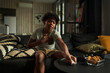 © pressmaster - Cute African American boy with asthma attack sitting on couch and keeping hand on chest while taking inhaler