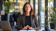 © Arpan - Professional woman takes a break to meditate at her office, promoting wellness.