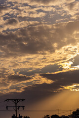 Wall Mural - silhouette of electric pole and sky with sunlight at sunset.