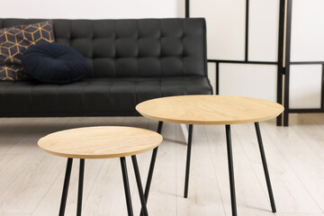 Poster - Nesting tables and comfortable sofa in room. Interior design