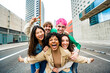 © Davide Angelini - Happy multiracial friends having fun on city street - Group of young people smiling at camera outside - Friendship concept with guys and girls walking in downtown road