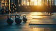 © Andrew - Gym Kettlebells at Sunset: Three kettlebells rest on a gym floor, bathed in the warm glow of a setting sun, symbolizing fitness, strength, and wellness.