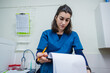 © Daniel Gonzalez/Stocksy - Veterinarian Writing Notes in Clinical Office