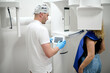 © Iuliia Versta/Stocksy - woman doing teeth roentgen at light medical clinic