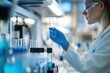 © Anat art - Scientist examines test tube in modern laboratory environment during research