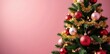 © Sutasinee - Pink and gold festive Christmas tree with ornaments, lights, and tinsel, holiday, decoration