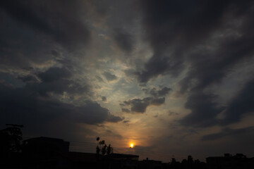 Wall Mural - sunset in the city with cloud and sky background. dark tone.