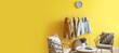 © Pixel-Shot - Comfortable chairs and hanger with jackets near yellow wall in room. Banner for design