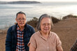 © Christine La/Stocksy - Elderly people walking by coast