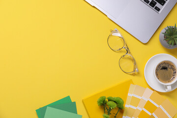 Aufkleber - Designer's workplace with laptop, stationery and cup of coffee on yellow background, flat lay. Space for text