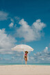 © Alina Hvostikova/Stocksy - Women enjoys a playful moment in clear tropical waters