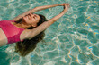 © Alina Hvostikova/Stocksy - Woman relaxing in turquoise water on a sunny day