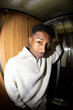 © Jimena Roquero/Stocksy - Portrait in elevator of young man looking at camera. Fisheye