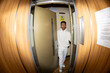 © Jimena Roquero/Stocksy - Young man entering elevator in building. Fisheye. Direct flash.