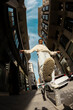 © Jimena Roquero/Stocksy - Fisheye angle of man jumping and dancing in city street