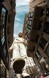 © Jimena Roquero/Stocksy - Fisheye. Full body. Man walking in city street in sunlight from below