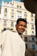 © Jimena Roquero/Stocksy - portrait of man walking in Madrid city street in sunlight