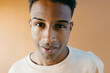 © Jimena Roquero/Stocksy - Studio portrait of young handsome man looking at camera