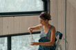 © Alina Hvostikova/Stocksy - Woman painting interior walls in cozy cabin during daytime