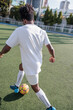 © Jovo Jovanovic/Stocksy - Player playing with soccer ball on pitch during sunny day