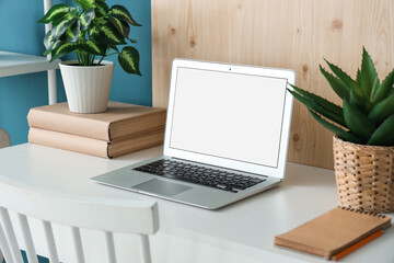 Wall Mural - stylish table with modern laptop and houseplant near blue wall in room