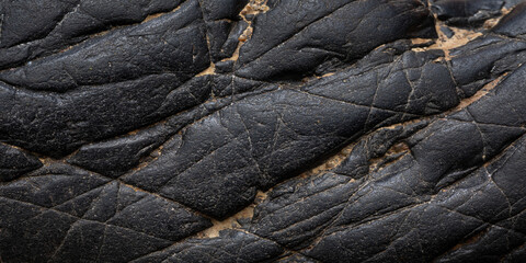 Wall Mural - black stone texture background. close up of a stone. close up of a pile of black stone. close up of 