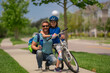 © Volodymyr - Fathers day. Happy family, men generations. Concept of friendly family and summer lifestyle. Happy loving family. Father and son hugging. Parents and children friends. Child first bike.