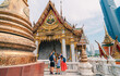 © avtk - A family visits an old temple in Bangkok