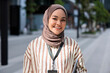 © Jovo Jovanovic/Stocksy - Portrait of smiling muslim female professional at office